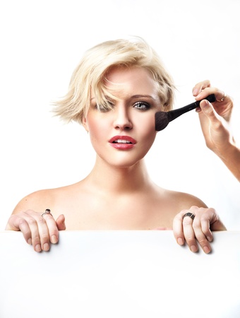Portrait of a woman doing make upの写真素材