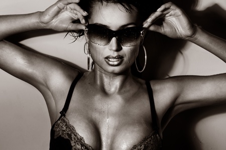 Sexy brunette posing with sunglasses の写真素材