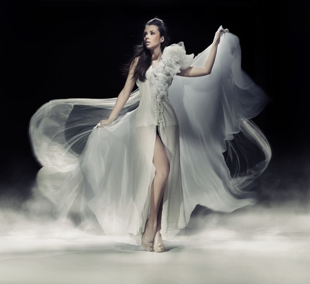 Sensual brunette woman in white dressの写真素材