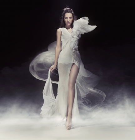 Beautiful brunette lady in white dressの写真素材