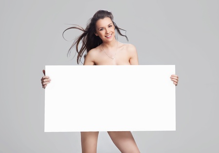 Young happy woman over white boardの写真素材