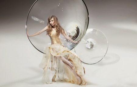 Perfect young beauty sitting on martini glassの写真素材