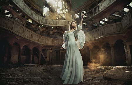 Beautiful angel in old, abandon placeの写真素材