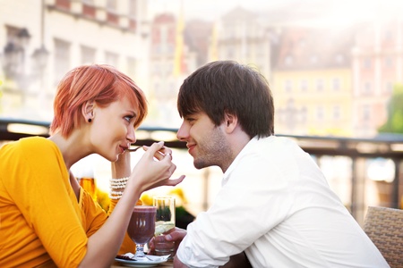 Cute young couple eating lunchの写真素材