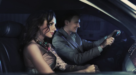 HAndsome pair driving at nightの写真素材