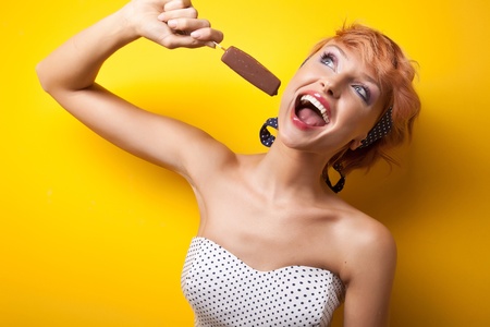 Beautiful smiling woman eating ice creamの写真素材