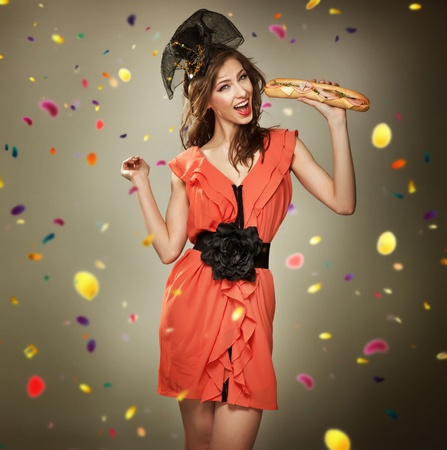 Cheerful young beauty holding casseroleの写真素材