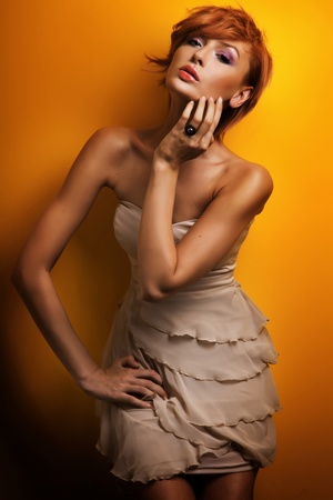 Fashion photo of beautiful redhead girl posing in sensual dressの写真素材