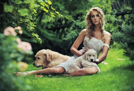 Cute woman with dogs in beauty nature sceneryの写真素材