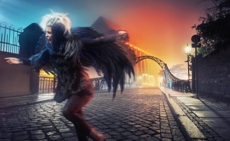 Raven woman running on empty city streetの写真素材
