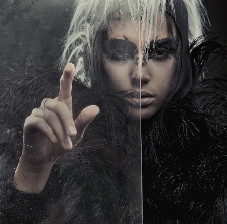 Mysterious woman pointing on somethingの写真素材