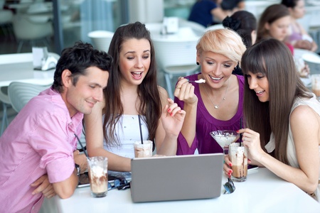 Young people browsing internet in a restaurantの写真素材