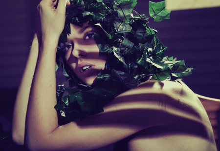 Fine art shot of a lady with green leafs hairstyleの写真素材