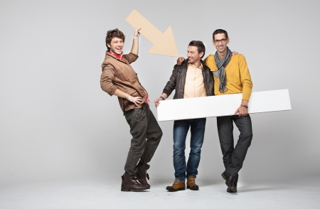 A band of male young friends with signsの写真素材