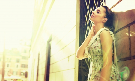 Young brunette tired lady enjoying the sunの写真素材