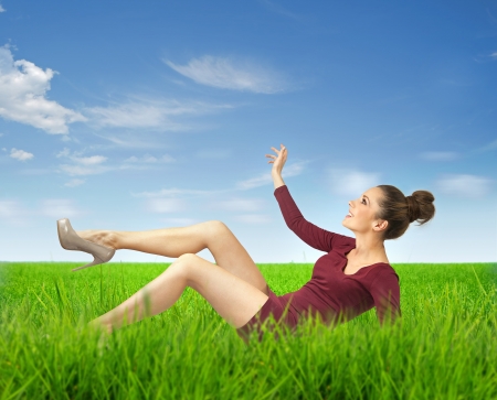 Attractive brunette lady lying on grassの写真素材