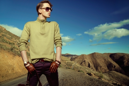 Fashion photo shot of a young man wearing glovesの写真素材