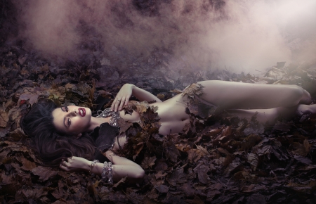 Fantastic shot of sensual brunette woman on the leaf's duvetの写真素材