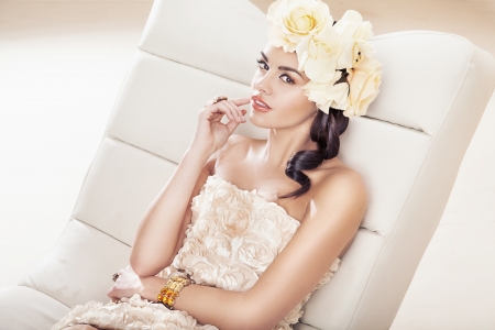 Pretty brunette girl with fabulous flower hatの写真素材