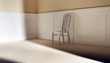 Bright interior with old chair against wallの写真素材