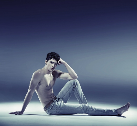 Muscular young man in sexy poseの写真素材