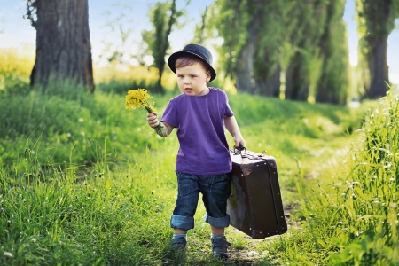 Young boy with big suitcaseの写真素材