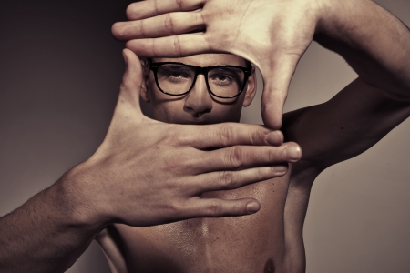 Portrait of guy making a square by handsの写真素材