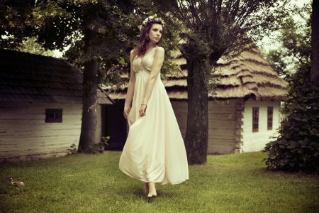 Lady in white dress dancing on the fresh grassの写真素材