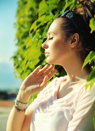 Cute brunette relaxing in the large gardenの写真素材