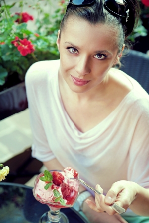 Pleased brunette lady with fine dessertの写真素材