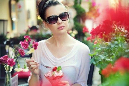 Young lady posing with fancy fruit dessertの写真素材
