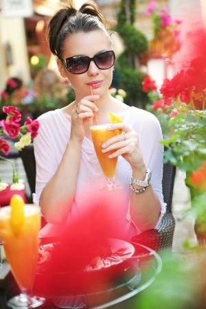 Thirsty woman drinking an orange juiceの写真素材