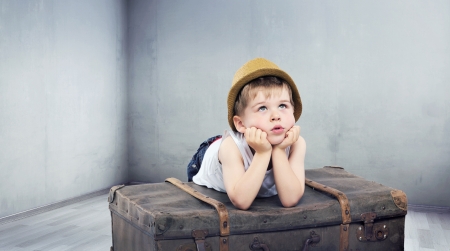 Little cute boy dreaming about toysの写真素材