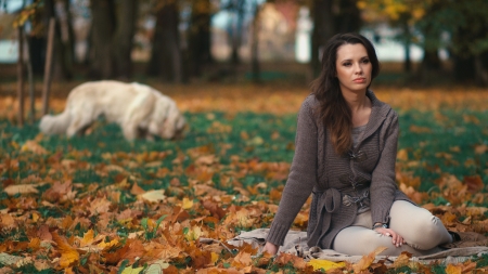 Portrait of the relaxing woman with her dog in the backgroundの写真素材