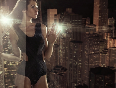 Brunette behind the window of the luxury apartmentの写真素材