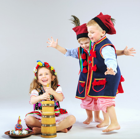 Three little children wearing traditional costumesの写真素材