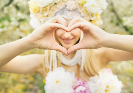 Beautiful woman and the love gestureの写真素材