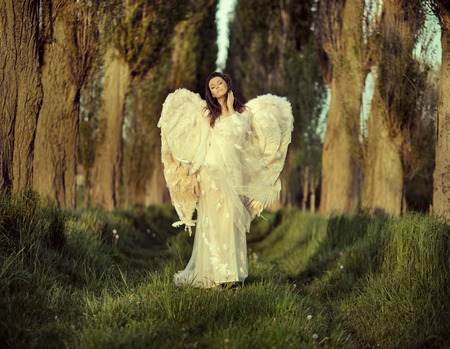 Wonderful female angel walking across the spring forestの写真素材