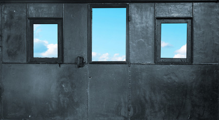 Three small windows in the metal roomの写真素材