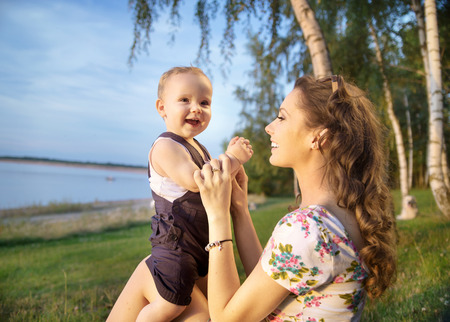 Young mom making her baby laughing