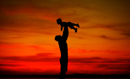 Dad tossing his lovely babyの写真素材