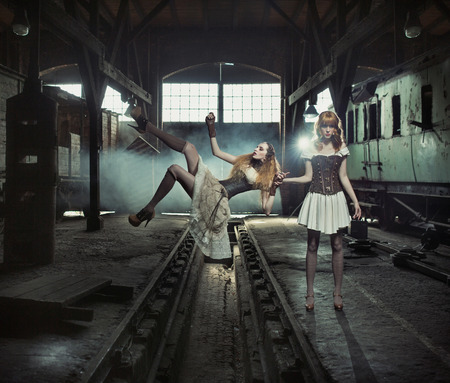 Two sensual witches in the old and empty railway station