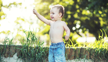 Small kid playing in the gardenの写真素材