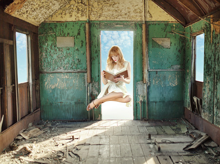 Levitating redhead reading in the hovelの写真素材
