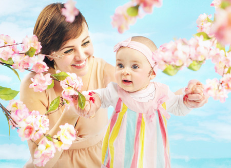 Smiling mom holding her little daughterの写真素材