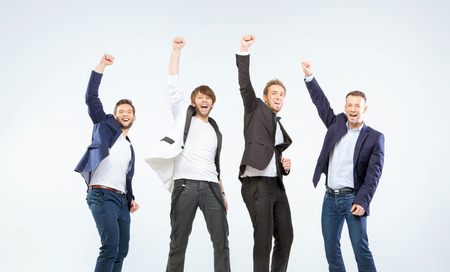 Four boys making a victory gestureの写真素材