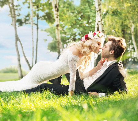 Marriage couple lying on the fresh lawnの写真素材