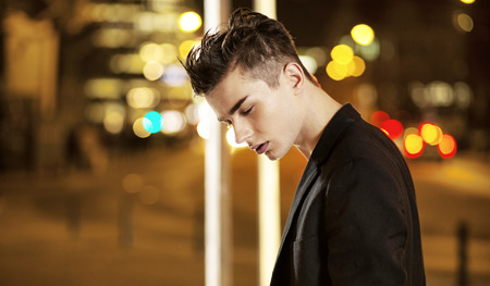 Serious young man in the middle of the nightの写真素材