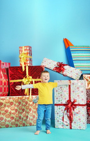 Cute little boy with plenty of presentsの写真素材