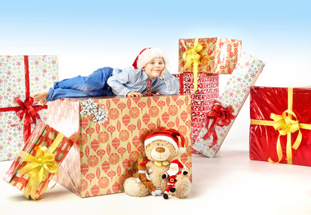 Little cute boy with plenty of presentsの写真素材